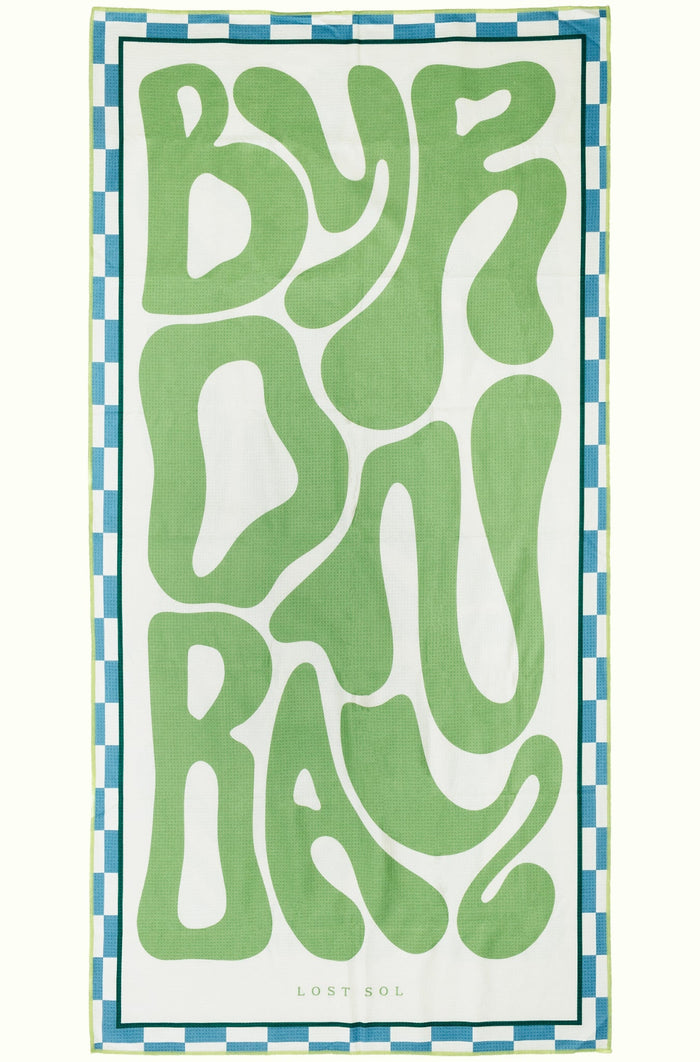 Byron Bay Pastel sand-free beach towel in soft eucalyptus green by Lost Sol, laid flat on a yellow background