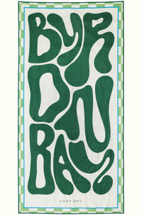 Byron Bay Bold sand-free beach towel in deep green by Lost Sol, laid flat on a yellow background