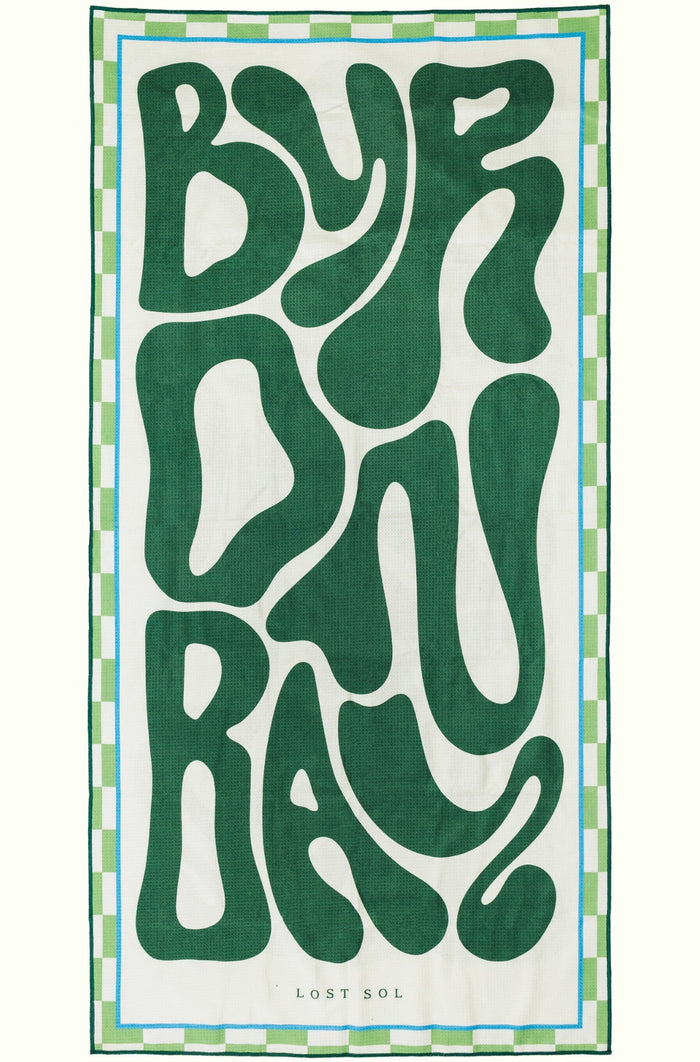Byron Bay Bold sand-free beach towel in deep green by Lost Sol, laid flat on a yellow background