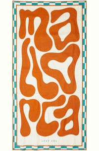 Mallorca Bold sand-free beach towel in burnt orange by Lost Sol, laid flat on a yellow background