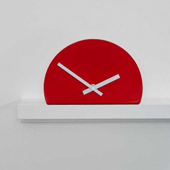 Metal shelf clock, red, half shape, and white hands. EDGE CLOCK by Thelermont hupton