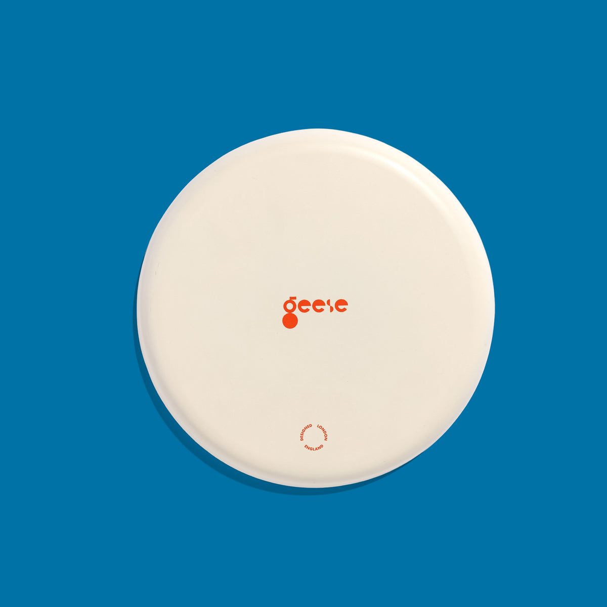 Zoom round enamel tray with multicoloured circles in blue, pink, yellow and green by Geese