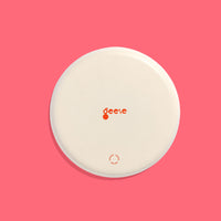 Zoom round enamel tray with multicoloured circles in orange, blue, black and pink by Geese