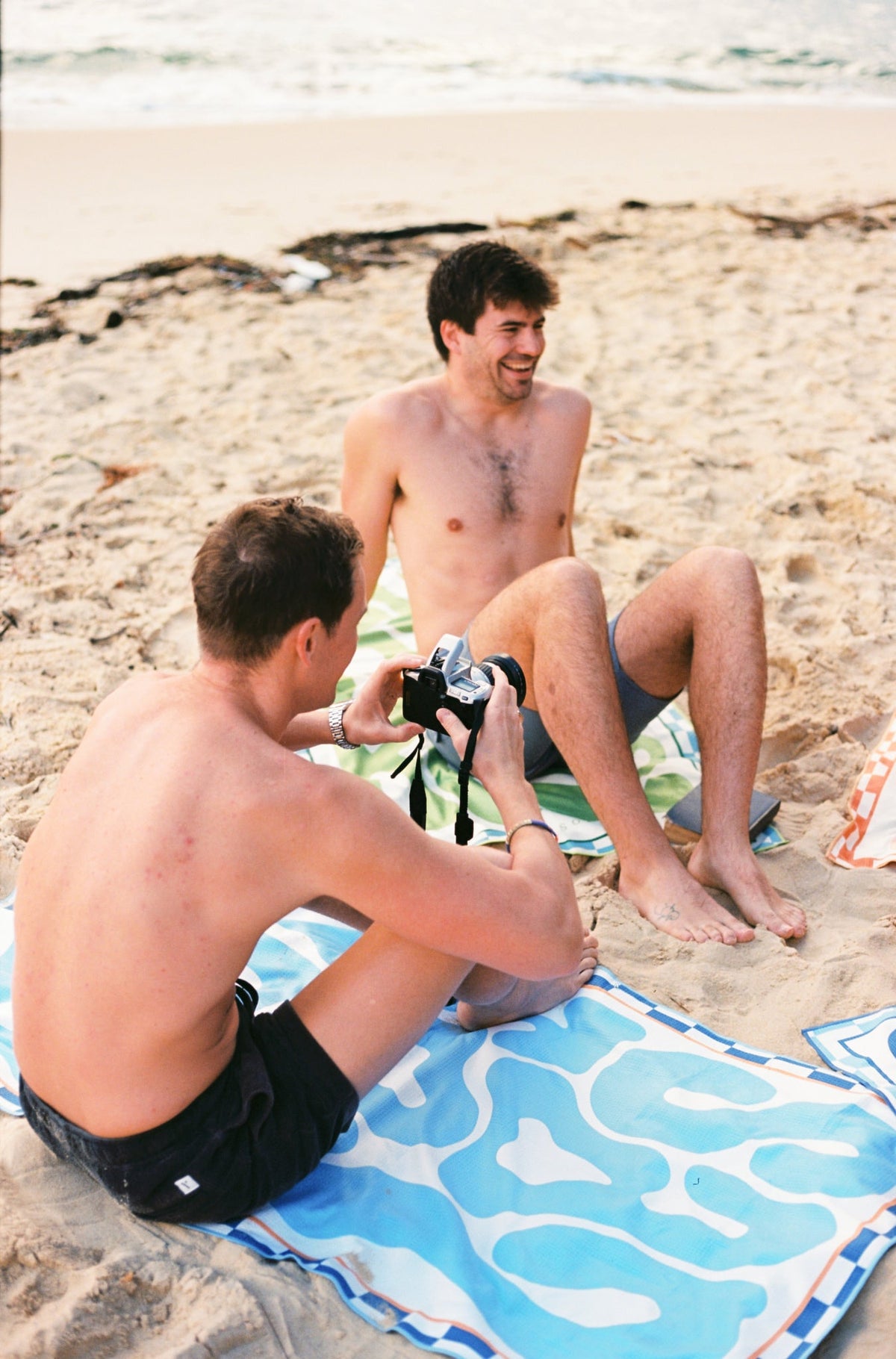 Santorini Pastel soft sky blue beach towel shaking sand-free on the beach, Lost Sol lifestyle photo