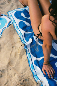 Lost Sol Santorini Bold deep blue and white lightweight travel towel, lifestyle photo