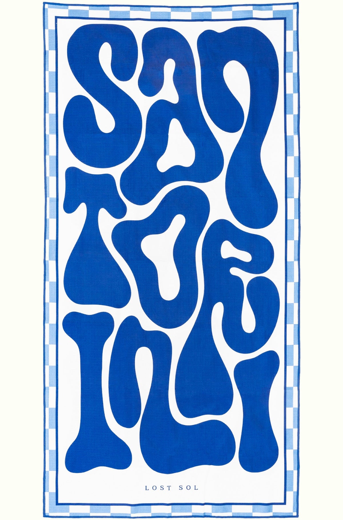 Santorini Bold sand-free beach towel in deep blue and white by Lost Sol, laid flat on a yellow background