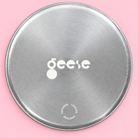 Zeus round enamelled aluminium tray with a black star motif by Geese
