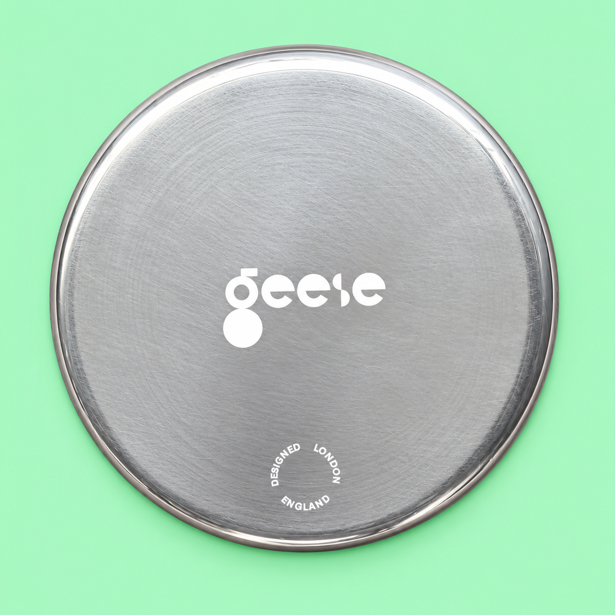 Zeus round enamelled aluminium tray with a red star motif by Geese