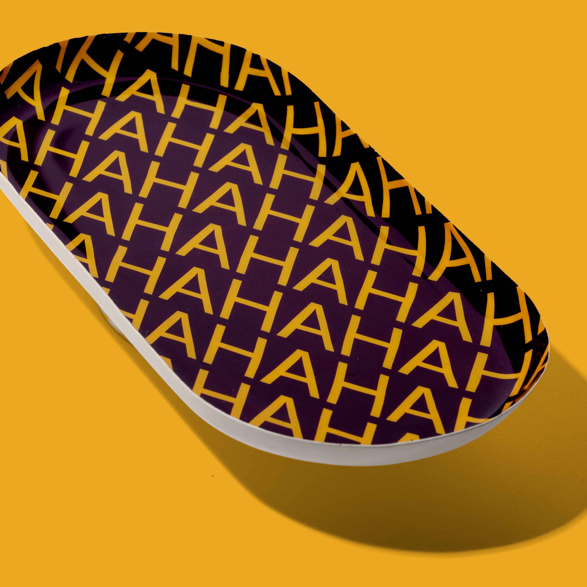 Zaha capsule enamel tray in deep purple with HAHAHA lettering in yellow by Geese