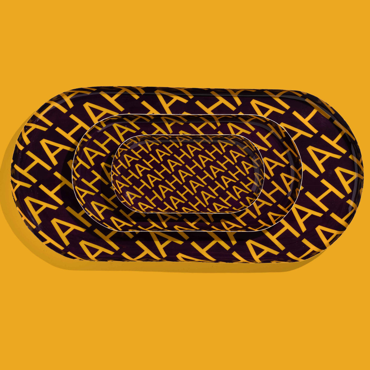 Zaha capsule enamel tray in deep purple with HAHAHA lettering in yellow by Geese