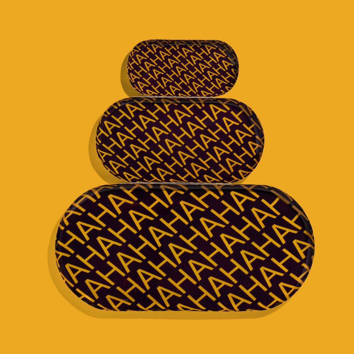 Zaha capsule enamel tray in deep purple with HAHAHA lettering in yellow by Geese