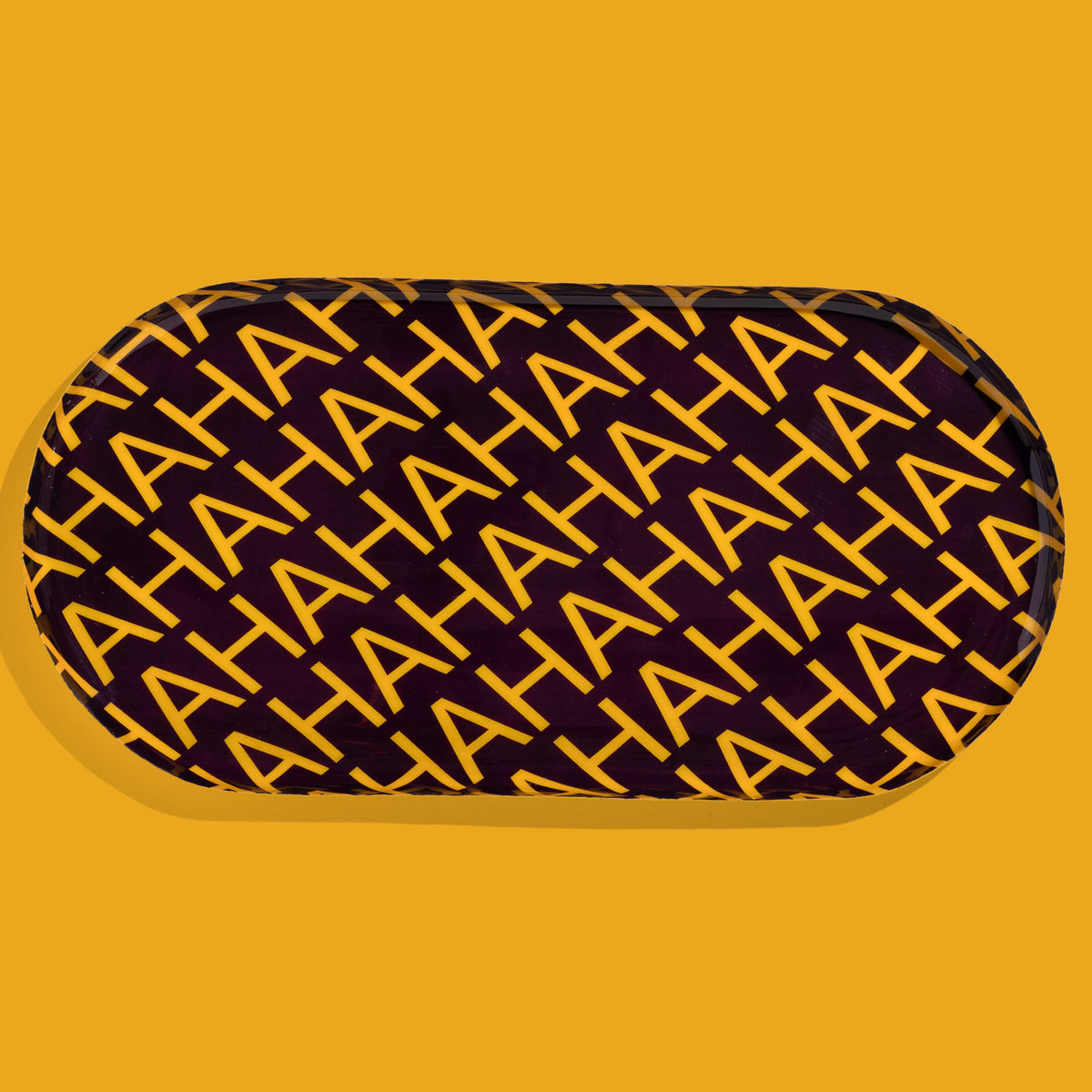 Zaha capsule enamel tray in deep purple with HAHAHA lettering in yellow by Geese
