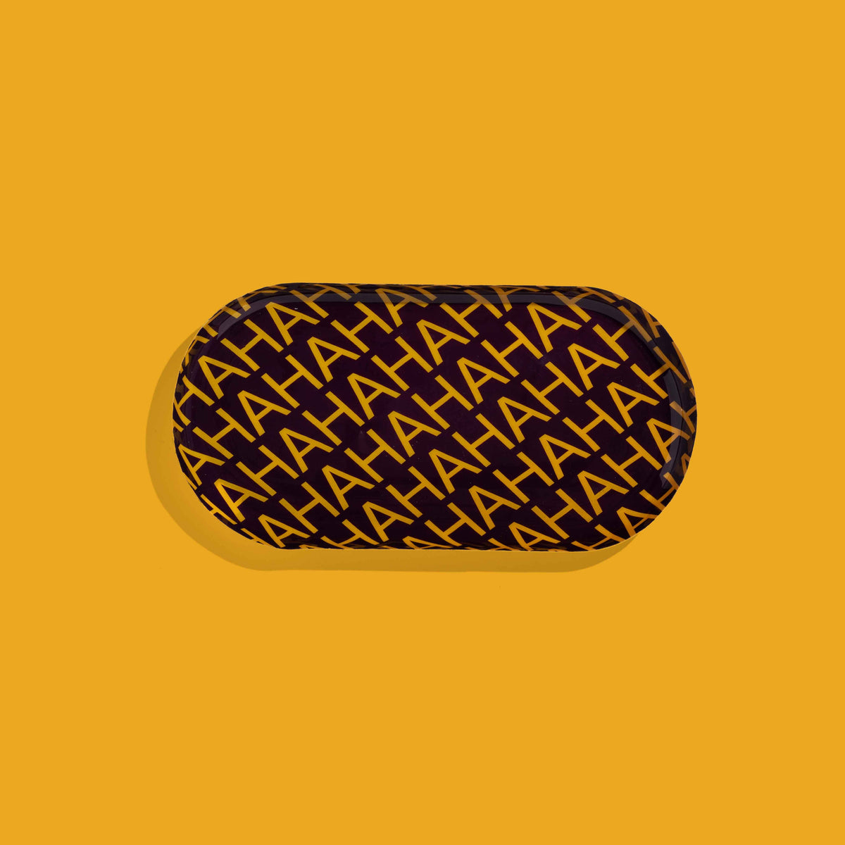 Zaha capsule enamel tray in deep purple with HAHAHA lettering in yellow by Geese