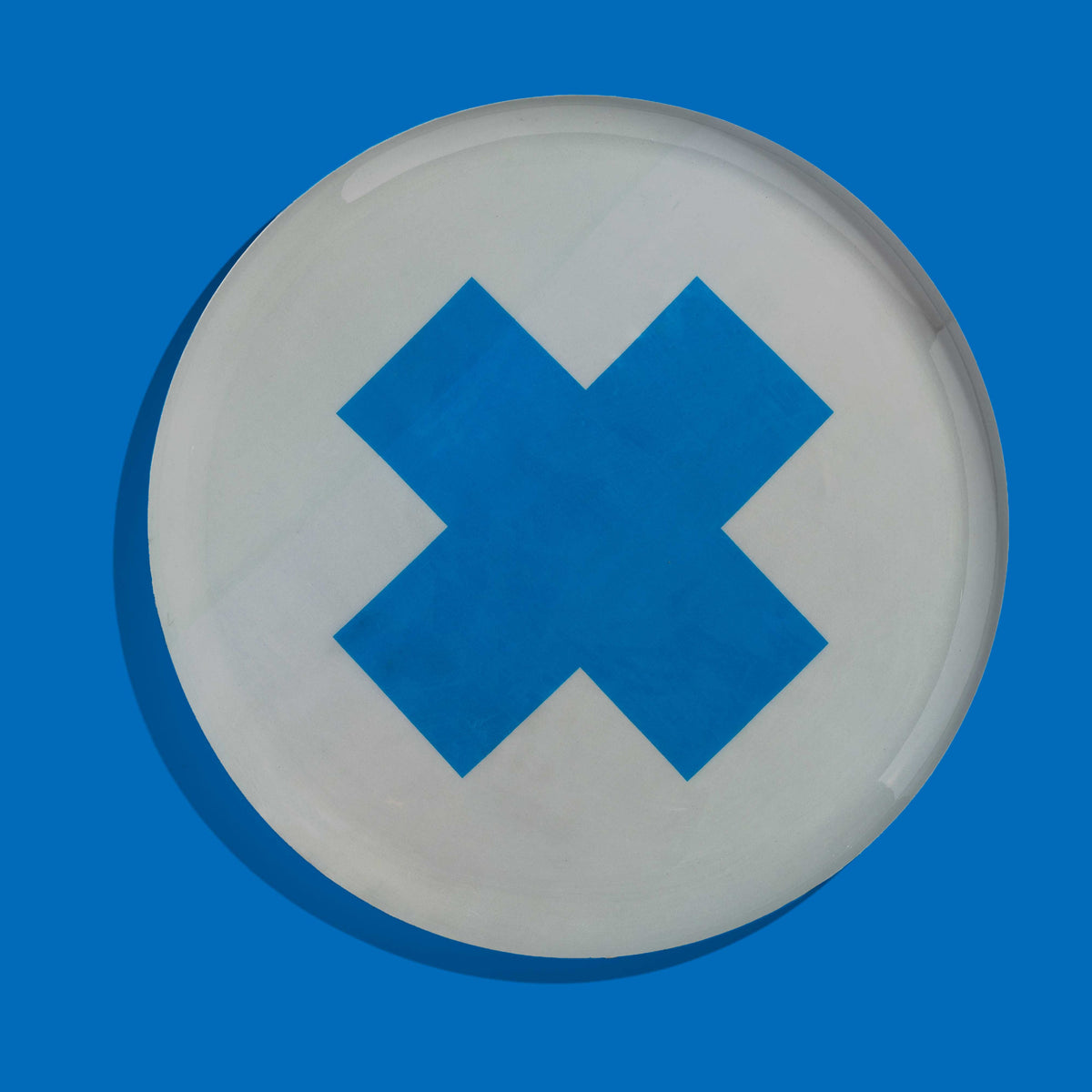Zeppelin round enamel tray in grey with a contrast blue cross design by Geese