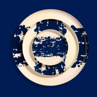 Zero round enamel tray in cream with a large abstract dark blue splash by Geese