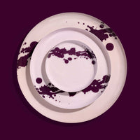 Zilla round enamel tray in pink with an abstract purple splash design by Geese