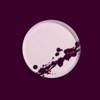 Zilla round enamel tray in pink with an abstract purple splash design by Geese