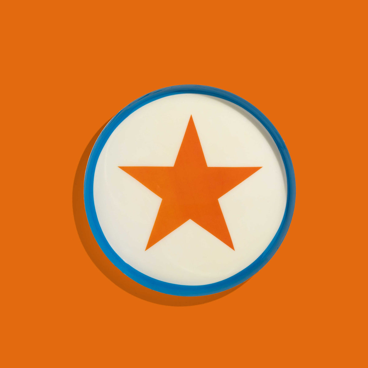 Zodiac round enamel tray in cream with an orange star and blue rim by Geese
