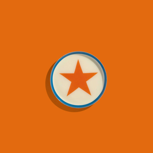 Zodiac round enamel tray in cream with an orange star and blue rim by Geese