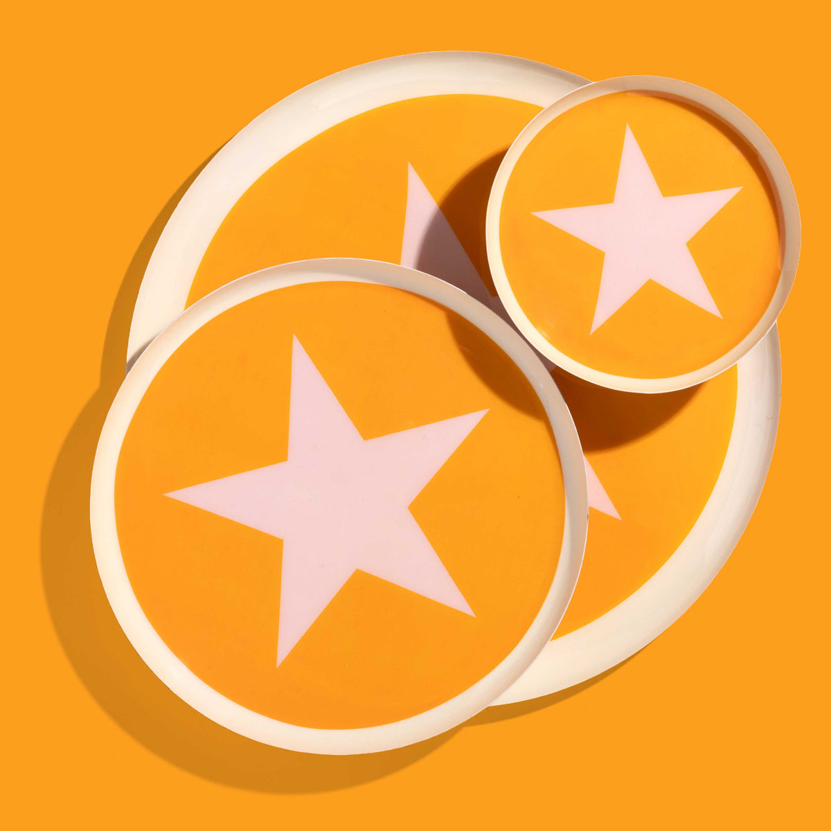 Zodiac round enamel tray in orange with a pale pink star and rim by Geese