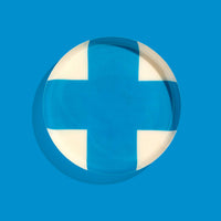 Zone round enamel tray in cream with a large blue cross by Geese