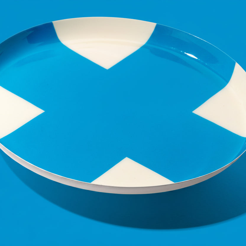 Zone round enamel tray in cream with a large blue cross by Geese