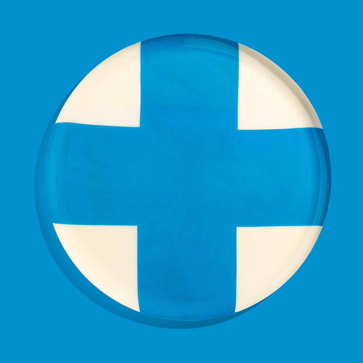 Zone round enamel tray in cream with a large blue cross by Geese