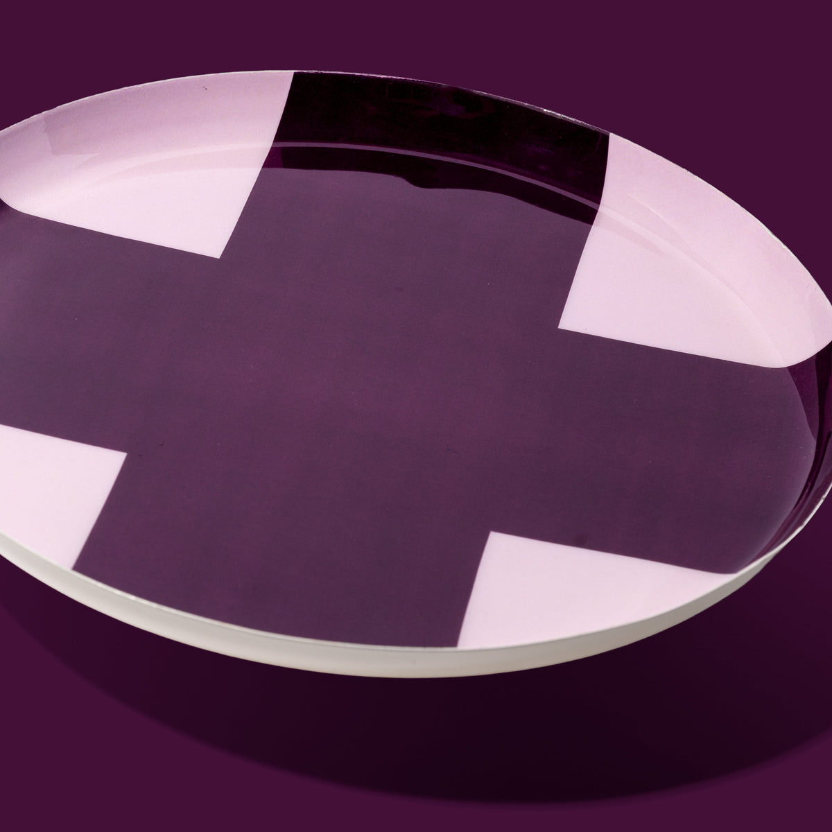 Zone round enamel tray in pink with a large purple cross by Geese