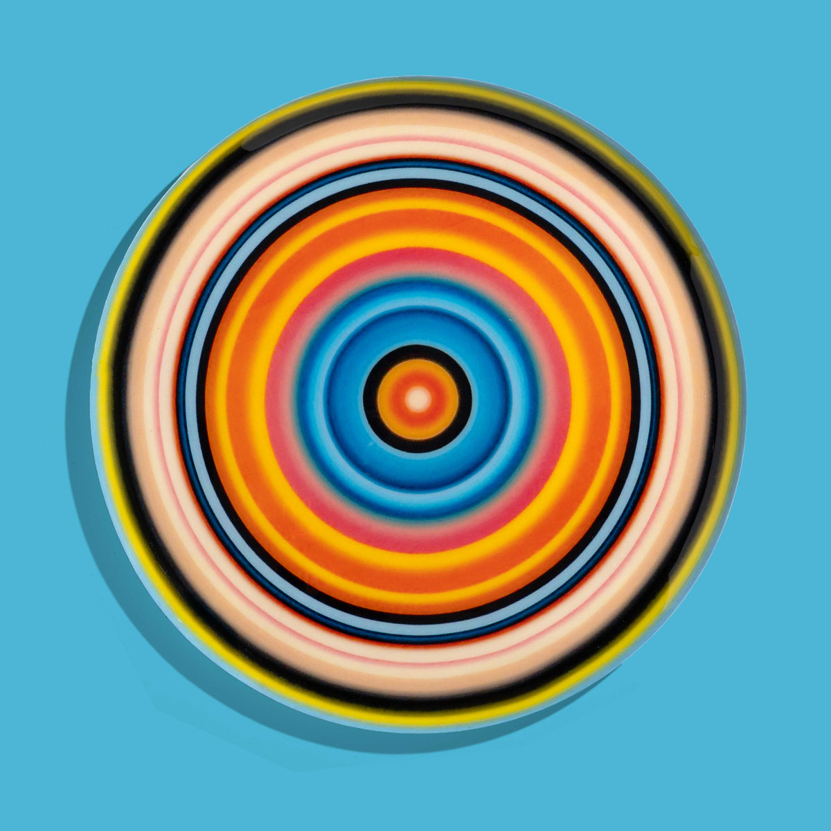 Zoom round enamel tray with multicoloured circles in pink, blue, orange, yellow and black by Geese
