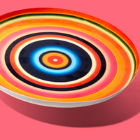 Zoom round enamel tray with multicoloured circles in orange, blue, black and pink by Geese