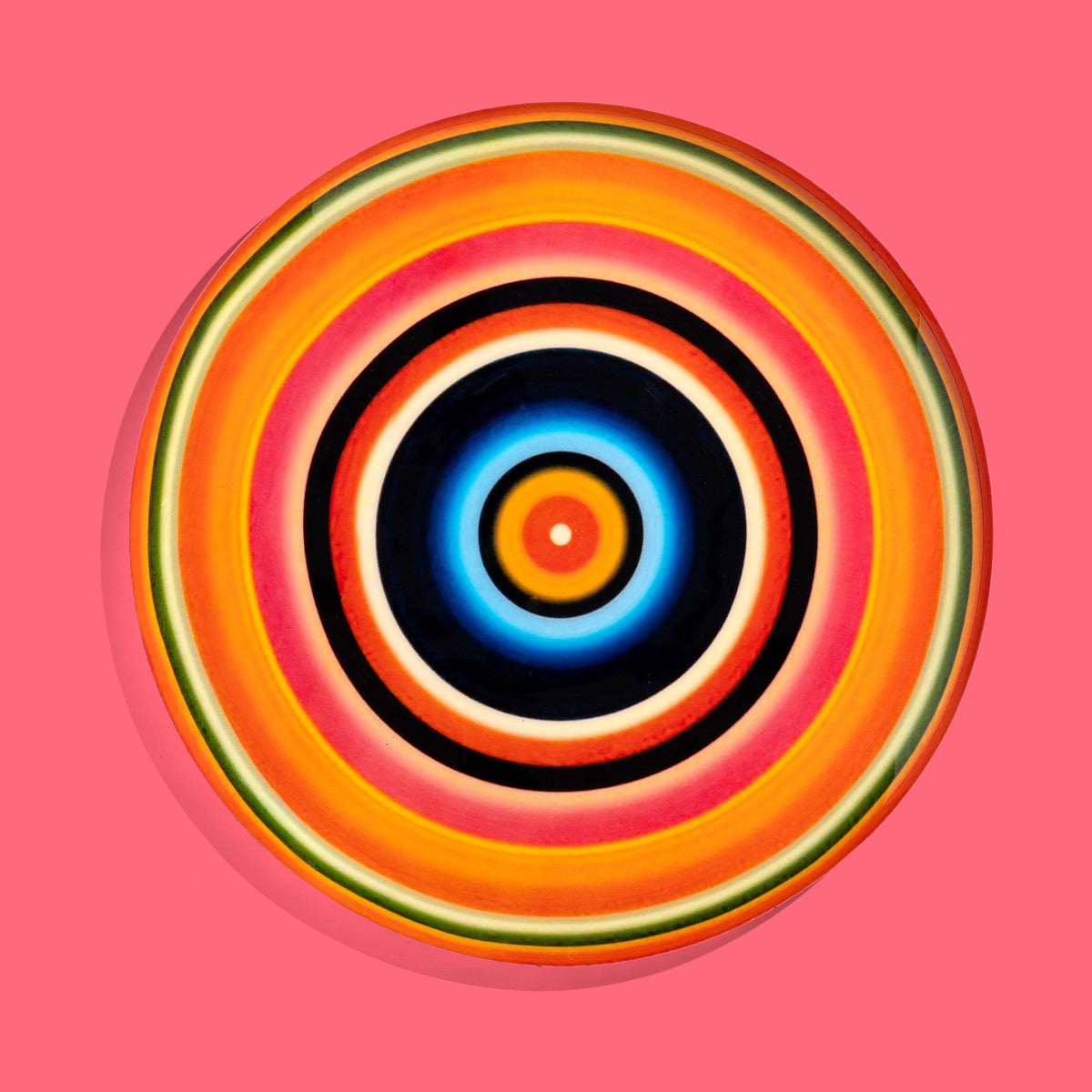 Zoom round enamel tray with multicoloured circles in orange, blue, black and pink by Geese