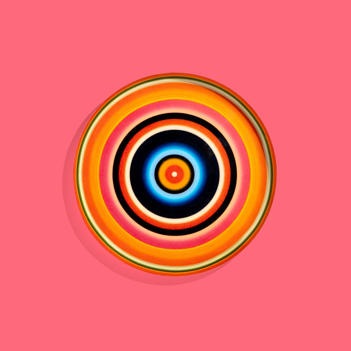 Zoom round enamel tray with multicoloured circles in orange, blue, black and pink by Geese