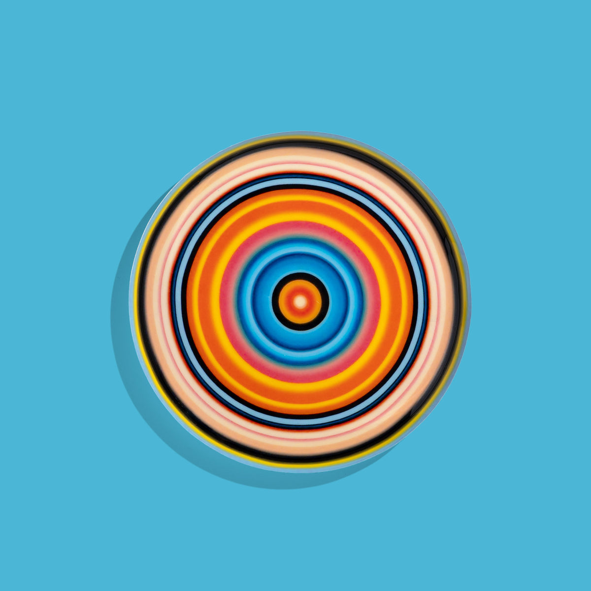 Zoom round enamel tray with multicoloured circles in pink, blue, orange, yellow and black by Geese