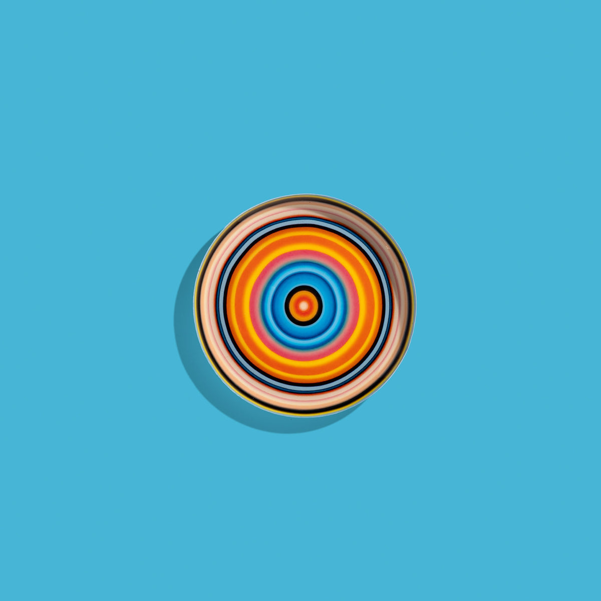 Zoom round enamel tray with multicoloured circles in pink, blue, orange, yellow and black by Geese