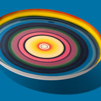 Zoom round enamel tray with multicoloured circles in blue, pink, yellow and green by Geese