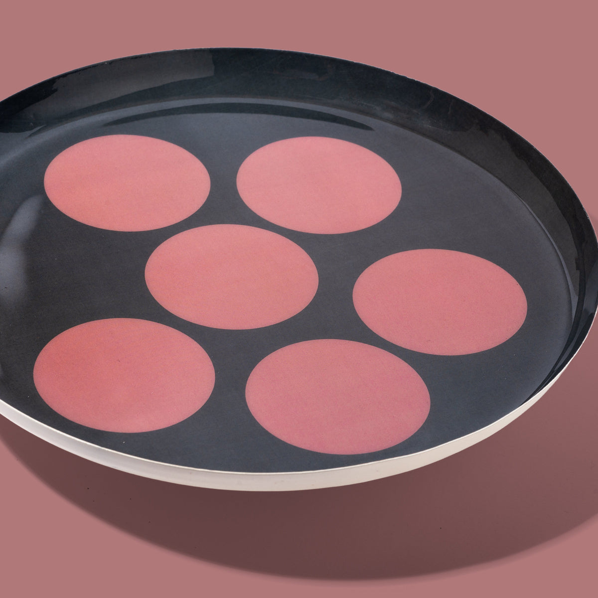 Zulu round enamel tray in dark grey with six pink dots by Geese