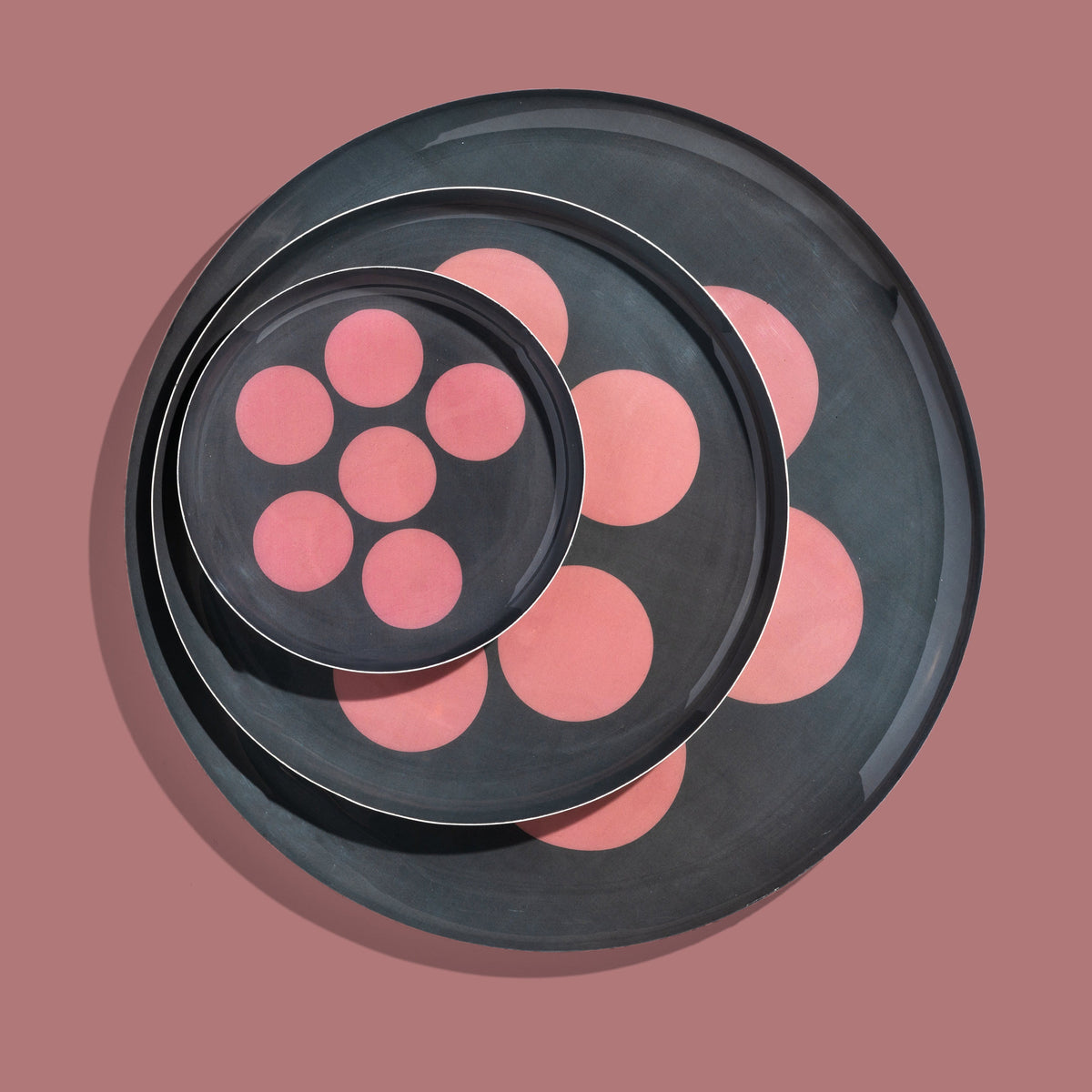 Zulu round enamel tray in dark grey with six pink dots by Geese