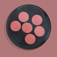 Zulu round enamel tray in dark grey with six pink dots by Geese