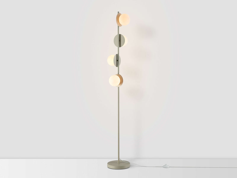 A vertical sand-coloured metal stem holds 4 metal disks at varying angles, each topped with an opal glass shade. Light is on.