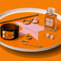 Zodiac round enamel tray in orange with a pale pink star and rim by Geese