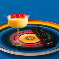 Zoom round enamel tray with multicoloured circles in blue, pink, yellow and green by Geese